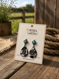 Hide and Halo earrings in turquoise on Myra branded card displayed on rustic wooden surface