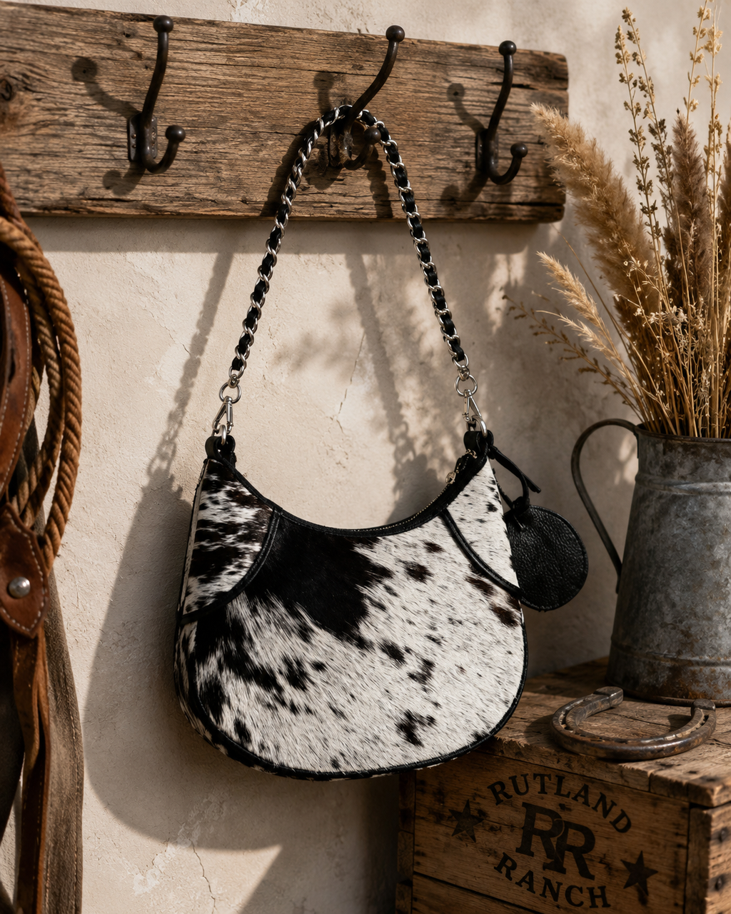 Loyal West Lueve hairon leather bag hanging on rustic hooks with Rutland Ranch branded crate in background