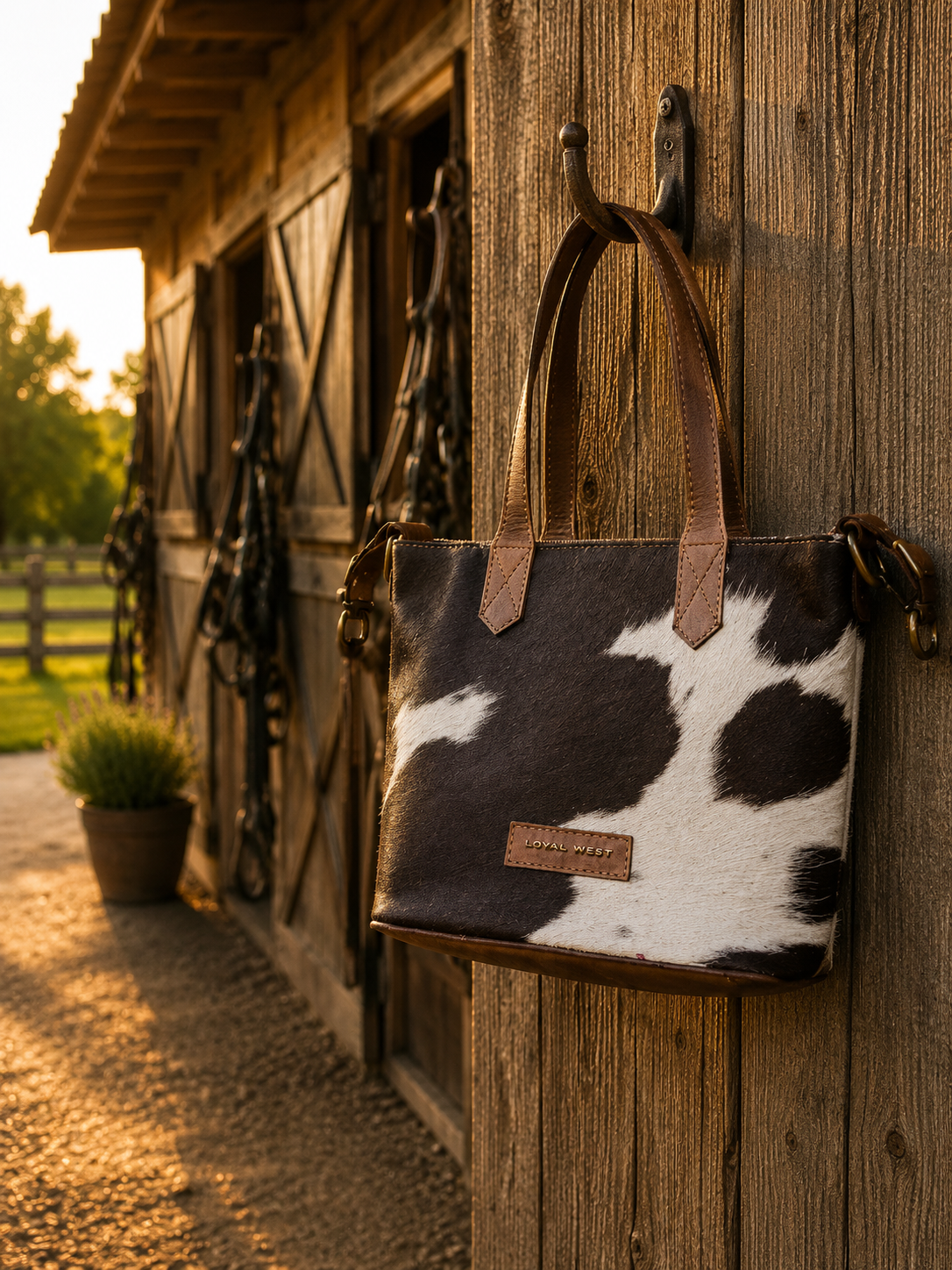 Dakota Medium CrossBody Black & White Cowhide - back view on barn hook