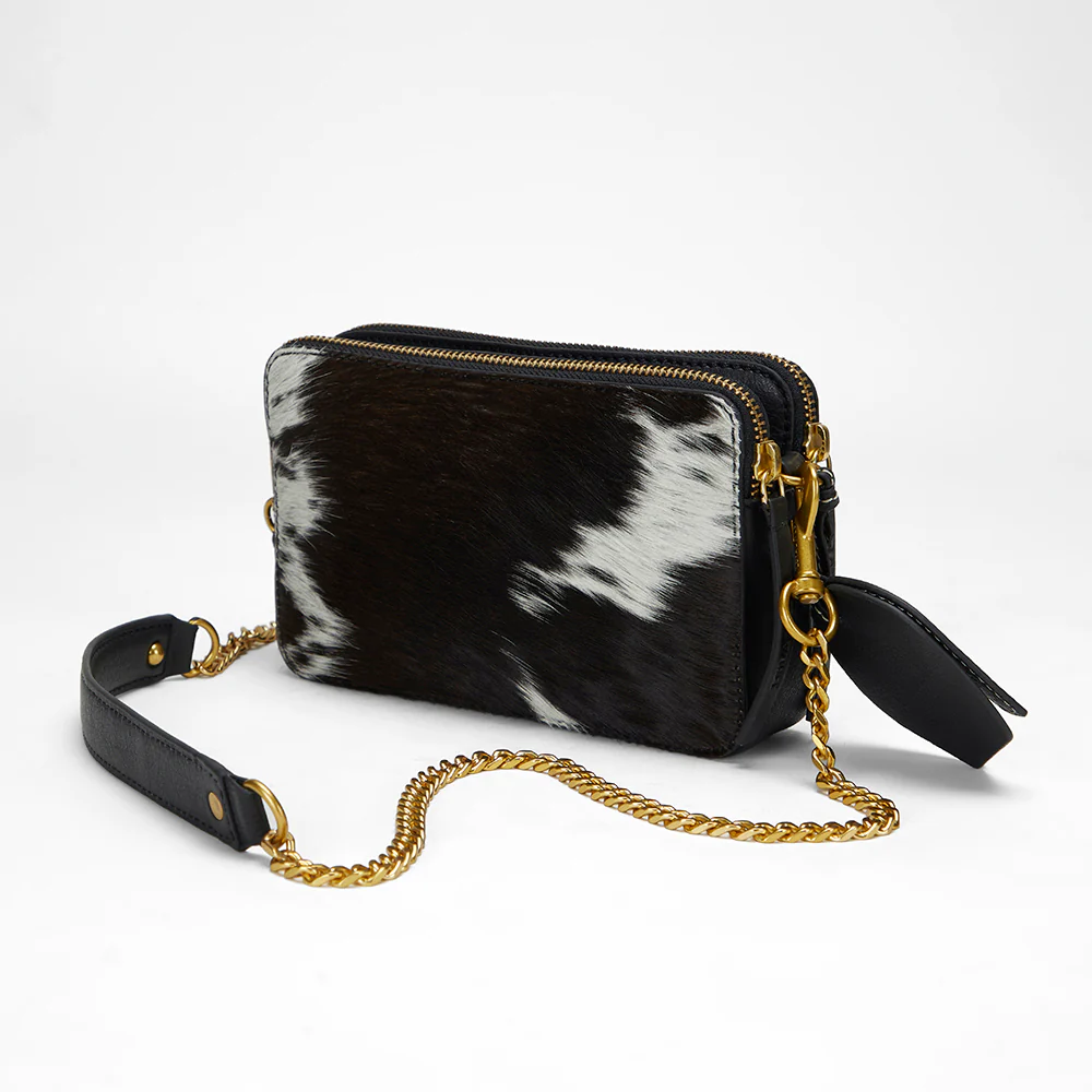 Loyal West Shell Mini Purse back view showing black and white cowhide pattern with gold chain and black leather crossbody strap