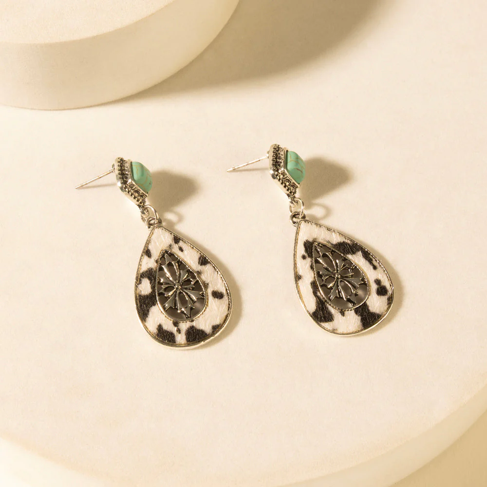 Hide and Halo earrings in turquoise close up showing cowhide teardrop and turquoise stud detail